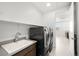 Convenient laundry room with modern washer and dryer, sink, and countertop space at 12039 Rockview Point St, Las Vegas, NV 89138
