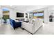Bright living room with a linear fireplace, wall-mounted TV, and large sliding glass doors at 12039 Rockview Point St, Las Vegas, NV 89138