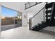 Sunlit staircase with metal railings and neutral tile floors with direct access to the outdoor patio space at 12039 Rockview Point St, Las Vegas, NV 89138
