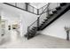 Modern staircase with metal railings and neutral tile floors leading to the upper level of the home at 12039 Rockview Point St, Las Vegas, NV 89138