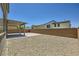 Spacious backyard featuring a covered patio, gravel landscaping, and privacy wall at 1213 Granite Falls Pl, North Las Vegas, NV 89084