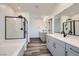 Modern bathroom featuring dual sinks, and a glass-enclosed shower with sleek fixtures at 1213 Granite Falls Pl, North Las Vegas, NV 89084