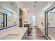 Modern bathroom featuring dual sinks, a soaking tub, and a glass-enclosed shower at 1213 Granite Falls Pl, North Las Vegas, NV 89084