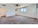 A spacious bedroom is illuminated by a ceiling fan and a large picture window at 1213 Granite Falls Pl, North Las Vegas, NV 89084