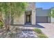 Inviting entryway featuring stone accents, a covered porch, and a well-maintained, drought-resistant landscape at 1213 Granite Falls Pl, North Las Vegas, NV 89084