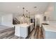 Bright and airy kitchen featuring a central island, stainless steel appliances, and open shelving at 1213 Granite Falls Pl, North Las Vegas, NV 89084
