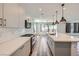 Well-lit kitchen boasting stainless steel appliances, quartz countertops, and herringbone backsplash at 1213 Granite Falls Pl, North Las Vegas, NV 89084