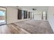 Spacious living room with carpet flooring, bright windows, and sliding glass doors to the outdoor space at 1213 Granite Falls Pl, North Las Vegas, NV 89084