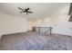 Spacious loft area with neutral carpeting, recessed lighting, and a ceiling fan at 1213 Granite Falls Pl, North Las Vegas, NV 89084