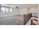 Bright loft featuring neutral carpeting, large windows offering pleasant views, and a ceiling fan at 1213 Granite Falls Pl, North Las Vegas, NV 89084