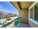 Private balcony with green railing overlooking a quiet street in a well-maintained community at 12282 Azure Gate Rd # 4, Las Vegas, NV 89183