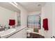 Bright bathroom with granite countertop, white vanity, a shower with tub and modern fixtures at 12282 Azure Gate Rd # 4, Las Vegas, NV 89183