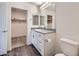Bathroom featuring a granite countertop vanity with dual mirrors and a walk-in closet at 12282 Azure Gate Rd # 4, Las Vegas, NV 89183