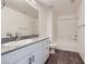 Modern bathroom featuring a granite countertop vanity, large mirror, and a shower-tub combination at 12282 Azure Gate Rd # 4, Las Vegas, NV 89183