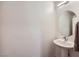 Elegant powder room featuring a pedestal sink, sleek faucet, and modern lighting fixture at 12282 Azure Gate Rd # 4, Las Vegas, NV 89183