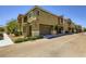 Exterior view showcasing a modern townhome with an attached garage and well-maintained landscaping at 12282 Azure Gate Rd # 4, Las Vegas, NV 89183