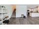 Spacious living room with adjacent staircase and kitchen featuring wood-look floors for a modern style at 12282 Azure Gate Rd # 4, Las Vegas, NV 89183