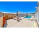 Backyard features a charming outdoor dining area, a pool, and stone landscaping at 1290 Dalene Ave, Henderson, NV 89002
