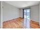 Empty bedroom with wood floors and sliding glass doors leading to a pool area at 1290 Dalene Ave, Henderson, NV 89002