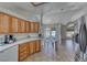 Bright kitchen with stainless steel refrigerator, wood cabinets and a convenient breakfast bar at 1290 Dalene Ave, Henderson, NV 89002
