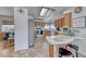 Inviting kitchen with wood cabinets and breakfast bar that offers a clear view of the space at 1290 Dalene Ave, Henderson, NV 89002