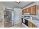 Kitchen featuring stainless steel refrigerator, and wood cabinets providing ample storage at 1290 Dalene Ave, Henderson, NV 89002
