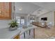 Bright and airy open floor plan featuring kitchen with a breakfast bar and view of the living area at 1290 Dalene Ave, Henderson, NV 89002