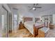 Bright main bedroom with a decorative wood bed frame and mirrored closet doors with ensuite bathroom at 1290 Dalene Ave, Henderson, NV 89002