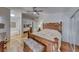 Spacious main bedroom boasts a decorative wood bed frame, mirrored closet doors, and an ensuite bathroom at 1290 Dalene Ave, Henderson, NV 89002