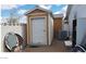 Wooden shed with roll-up door provides extra storage space at 1290 Dalene Ave, Henderson, NV 89002