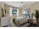 Bright bedroom featuring a large window with exterior views and neutral decor at 1306 Big Tree Ave, North Las Vegas, NV 89031