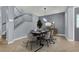 Modern dining room featuring a sleek table with seating for six, stylish lighting, and elegant decor at 1306 Big Tree Ave, North Las Vegas, NV 89031