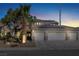 Beautiful two-story home with a three-car garage, desert landscaping, tile roof, and solar panels at 1306 Big Tree Ave, North Las Vegas, NV 89031