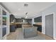 Bright kitchen featuring dark cabinetry, stainless steel appliances, and an island with a wooden countertop at 1306 Big Tree Ave, North Las Vegas, NV 89031