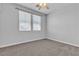Carpeted bedroom with neutral walls, ceiling fan and bright natural light from dual windows at 1346 Crystal Hill Ln # 3, Henderson, NV 89012