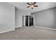 Well-lit bedroom with neutral carpet and dark doors that create a dramatic contrast at 1346 Crystal Hill Ln # 3, Henderson, NV 89012