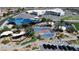 Aerial view of a community park featuring a splash pad, playground, and shaded picnic areas at 1346 Crystal Hill Ln # 3, Henderson, NV 89012