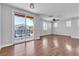 Bright living room featuring a sliding door to a balcony and attractive hardwood floors at 1346 Crystal Hill Ln # 3, Henderson, NV 89012