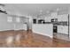 Open concept living space with hardwood floors and a connected kitchen at 1346 Crystal Hill Ln # 3, Henderson, NV 89012