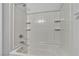 Clean, bright shower with white tile surround and built-in shelving for storage at 1346 Crystal Hill Ln # 3, Henderson, NV 89012