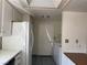 Functional kitchen space including a refrigerator and convenient access to the laundry area at 1590 Raindance Way, Las Vegas, NV 89169