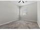 Empty bedroom features a ceiling fan, two windows, and herringbone floors at 18 Via Tiberina, Henderson, NV 89011