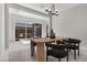 A dining room with sliding glass doors that lead to an outdoor seating area at 18 Via Tiberina, Henderson, NV 89011
