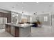 Bright, open-concept kitchen with a large island, stainless steel appliances, and seamless flow to the living area at 18 Via Tiberina, Henderson, NV 89011