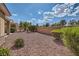 Expansive backyard with desert landscaping, secure fencing, and some green shrubs at 1816 Eagle Mesa Ave, Henderson, NV 89012