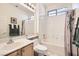 Well-lit bathroom with a shower-tub combo, neutral tile, and a stylish vanity at 1816 Eagle Mesa Ave, Henderson, NV 89012