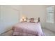 Cozy bedroom features plush carpet, a comfortable bed, and natural lighting through the window at 1816 Eagle Mesa Ave, Henderson, NV 89012