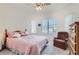 Comfortable bedroom with a ceiling fan, natural light, and plush carpeting at 1816 Eagle Mesa Ave, Henderson, NV 89012