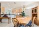 Inviting dining area with wood table and a lot of natural light with a view to kitchen at 1816 Eagle Mesa Ave, Henderson, NV 89012