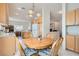 The kitchen features wooden cabinets and a round table with seating for four, lit by a pendant light at 1816 Eagle Mesa Ave, Henderson, NV 89012